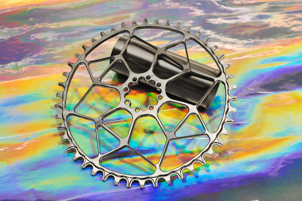 Sturdy titanium 1X chainring on an iridescent background