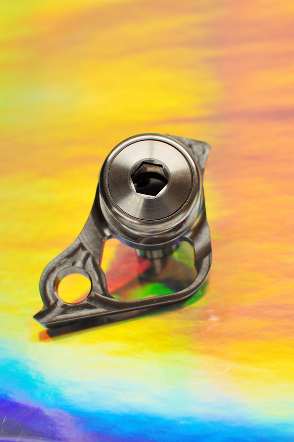 Sturdy titanium UDH derailleur hanger on an iridescent background