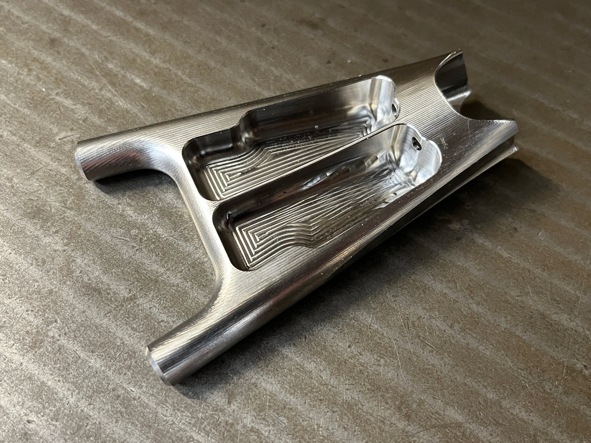 Underside of a titanium seat stay yoke showing its machined pockets