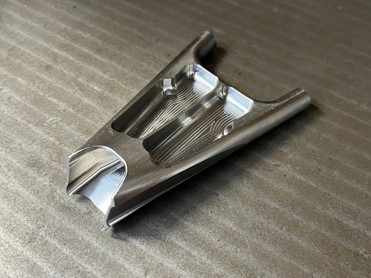 Titanium seat stay yoke from below, with lightening pockets cut into it