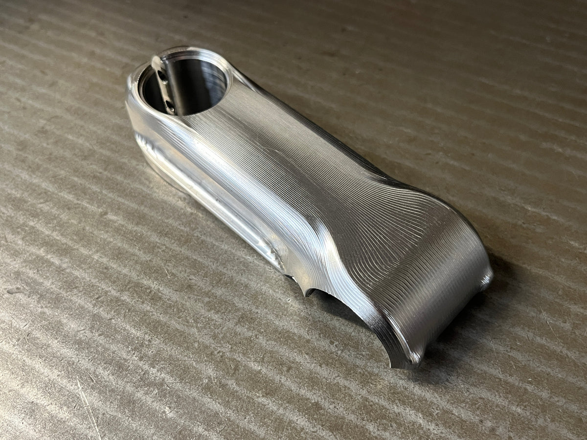 CNC machined titanium stem with a smooth tool-marked finish