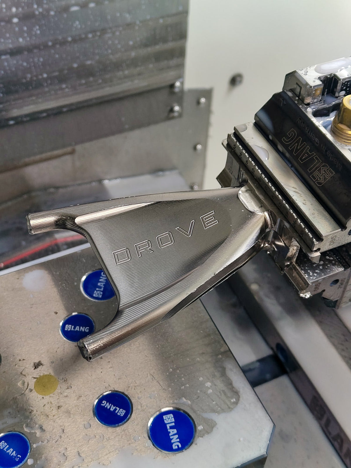 The Drove seat stay yoke in the machine vice, with DROVE cut into it