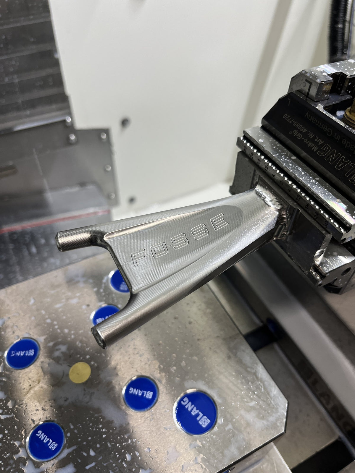 The Fosse seat stay yoke in the machine vice, with FOSSE cut into it