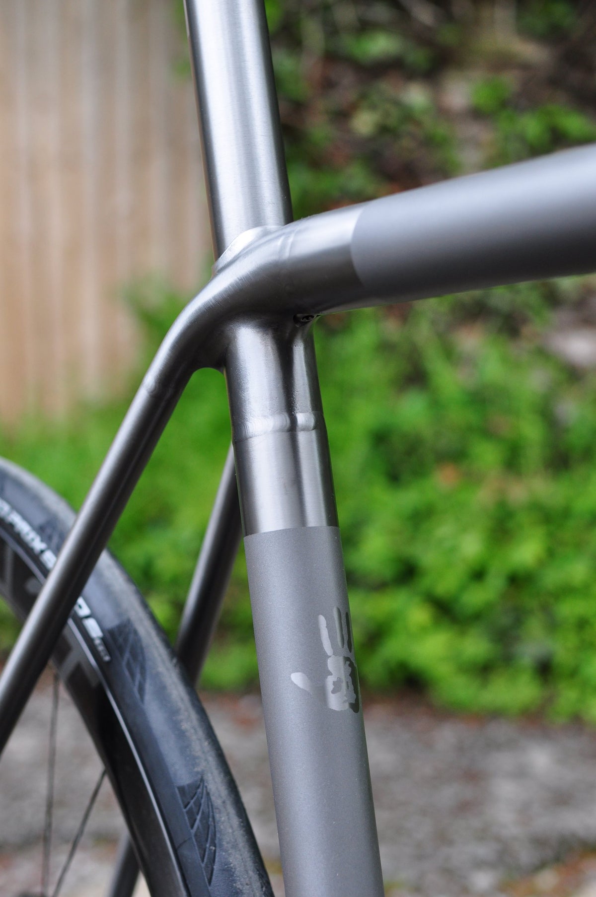 Titanium seat cluster with polished tube ends and a hand print graphic on the seat tube