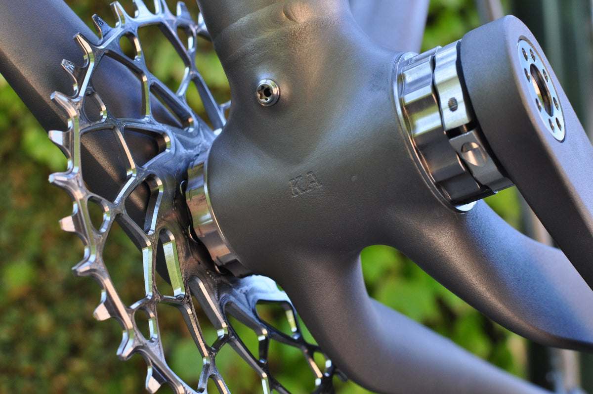 Machined chainring and polished bottom bracket on a shot-peened titanium frame with stamped initials