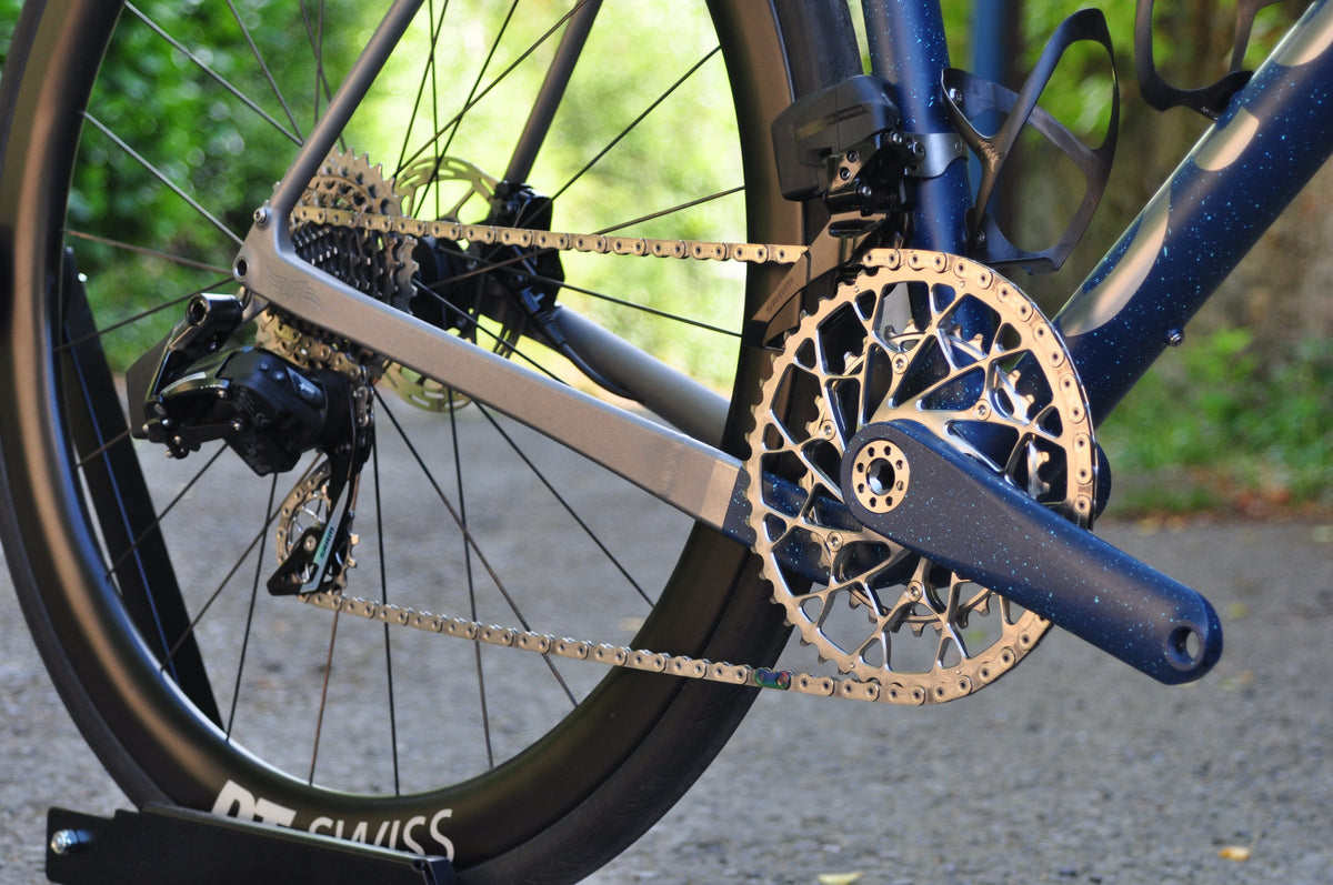 Drive side with titanium chainstay, machined chainring and navy speckled crank and down tube