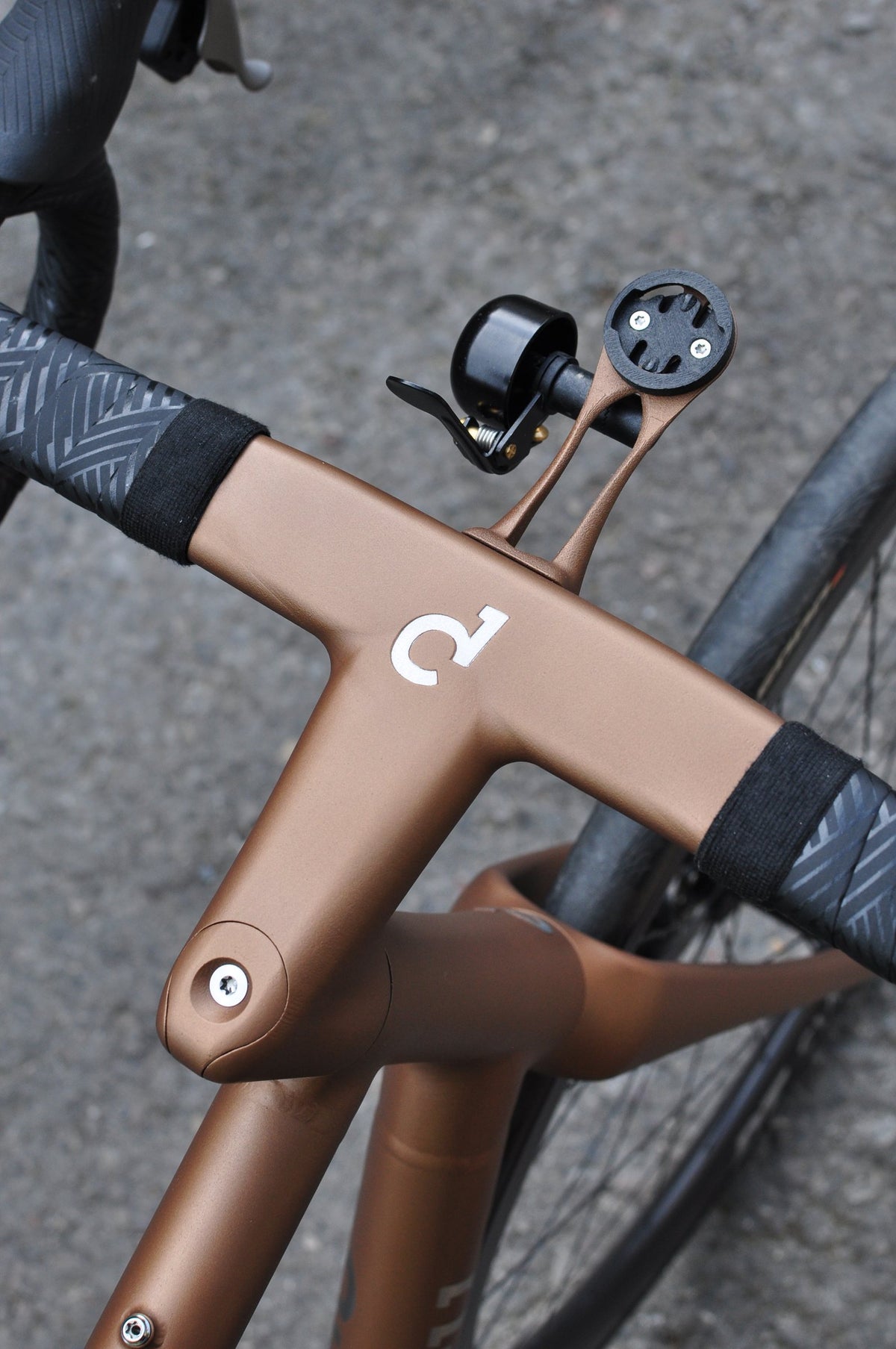 Copper painted one-piece bar and stem with Sturdy logo, bell and computer mount, seen from above