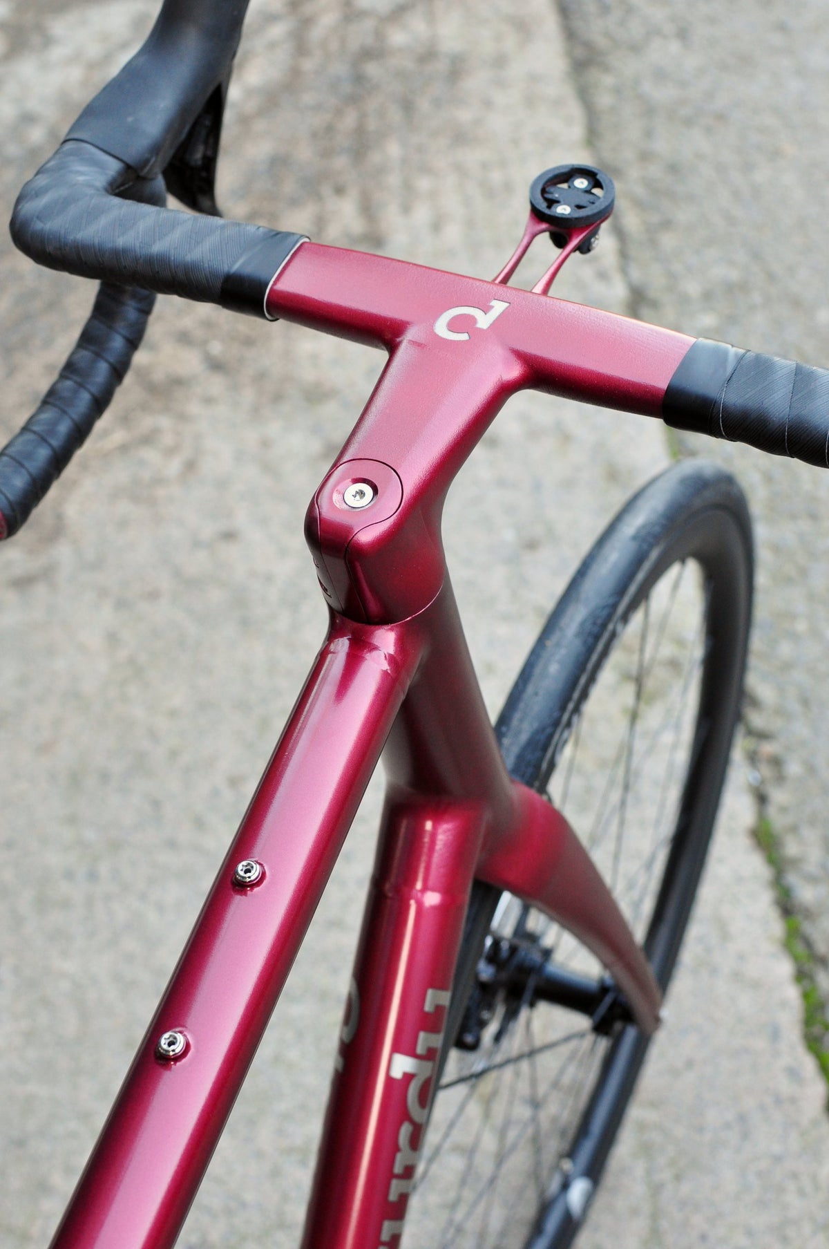 Metallic red painted frame and one-piece bar and stem with Sturdy logo and computer mount