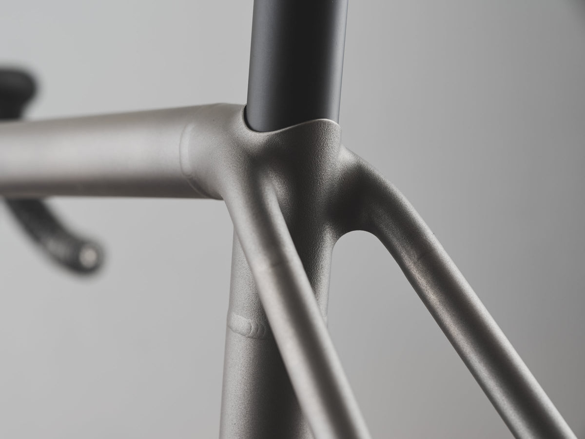 Shot-peened titanium seat cluster with smooth wishbone seatstay junction and dark seatpost