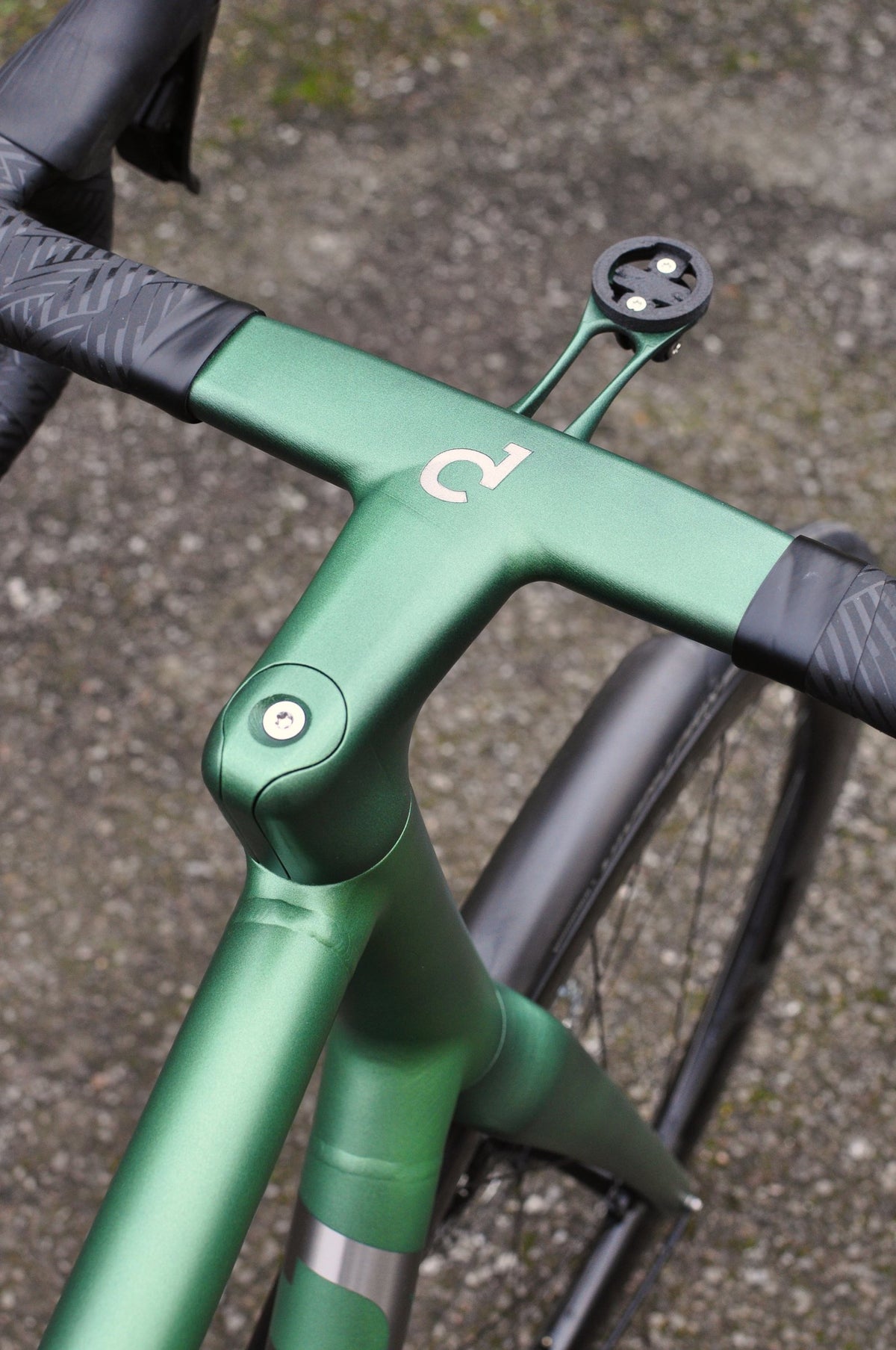 Metallic green one-piece bar and stem with Sturdy logo and computer mount, seen from above