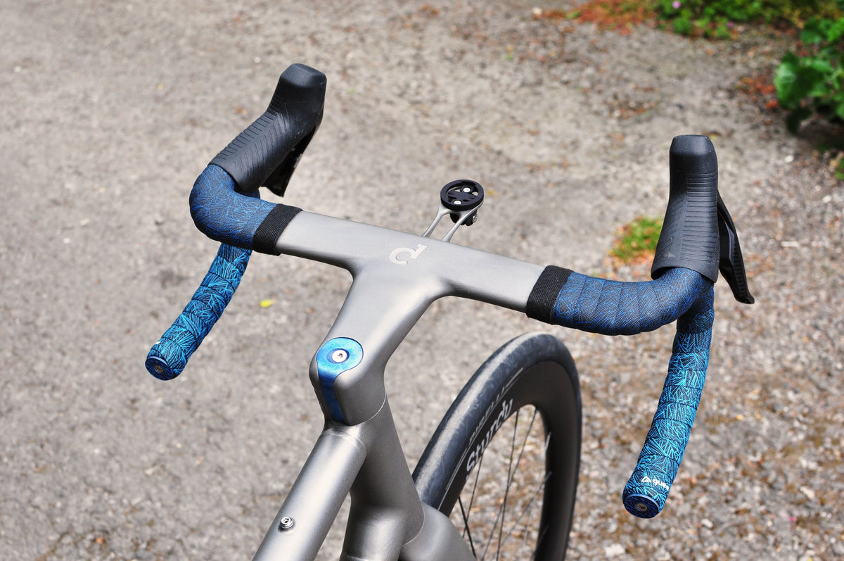 Titanium integrated handlebar with blue anodised top cap and blue patterned bar tape, from above