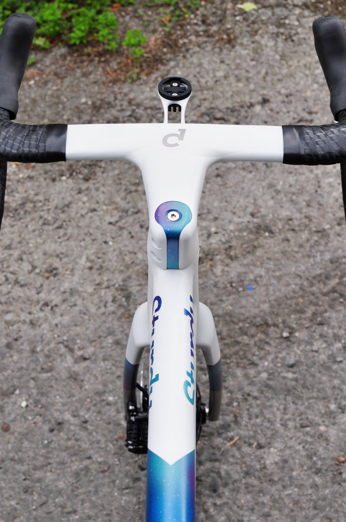 White integrated handlebar with Sturdy script and blue-purple anodised top cap, viewed from above