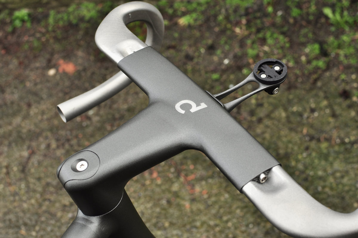 Dark grey one-piece bar and stem with titanium drops, Sturdy logo and computer mount from above