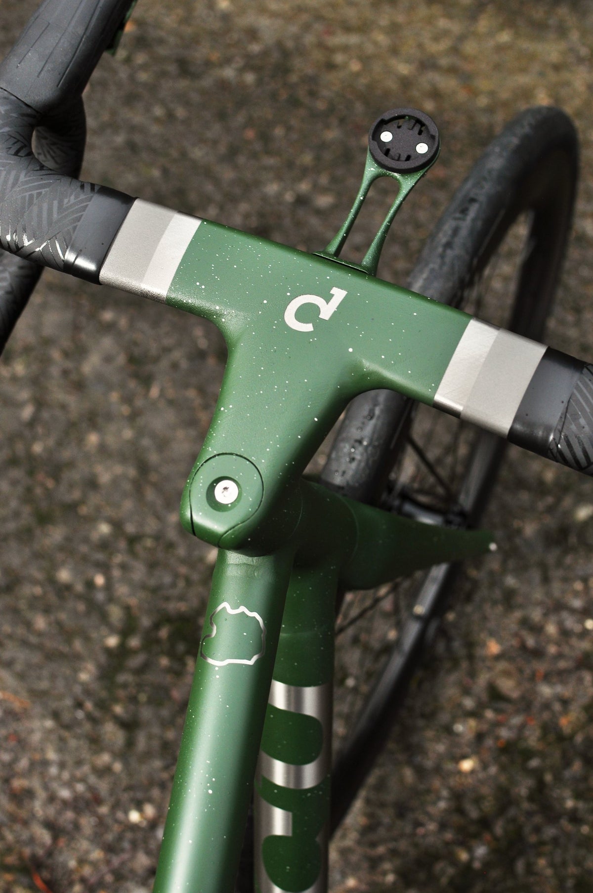Green speckled one-piece bar and stem with Sturdy logo and silver bands, seen from above